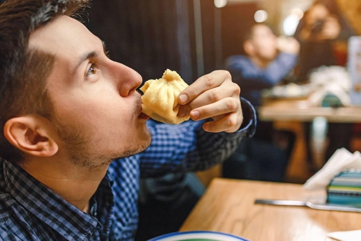 EXTRA. Hombre comiendo khinkali. Foto - Alamy